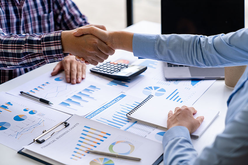 business-people-shaking-hands-over-financial-chart-2026-09-21-18-30-23-utc