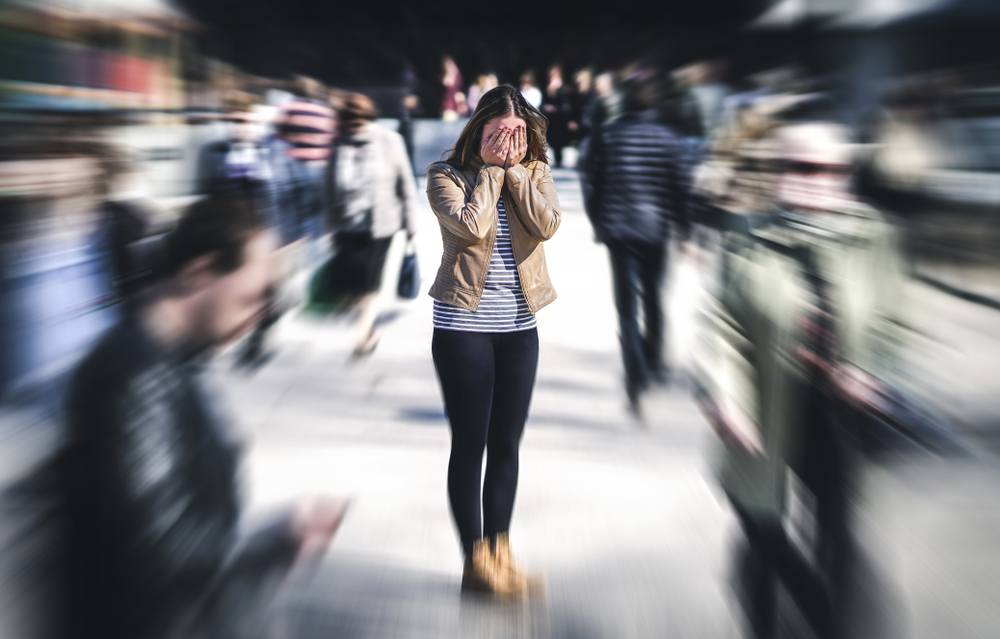 stresssed woman in crowd